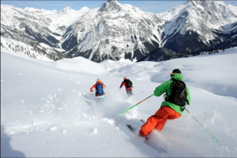 Skiers enjoying powder in Revelstoke